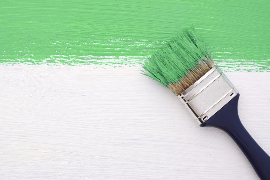 Brush painting green on a white background