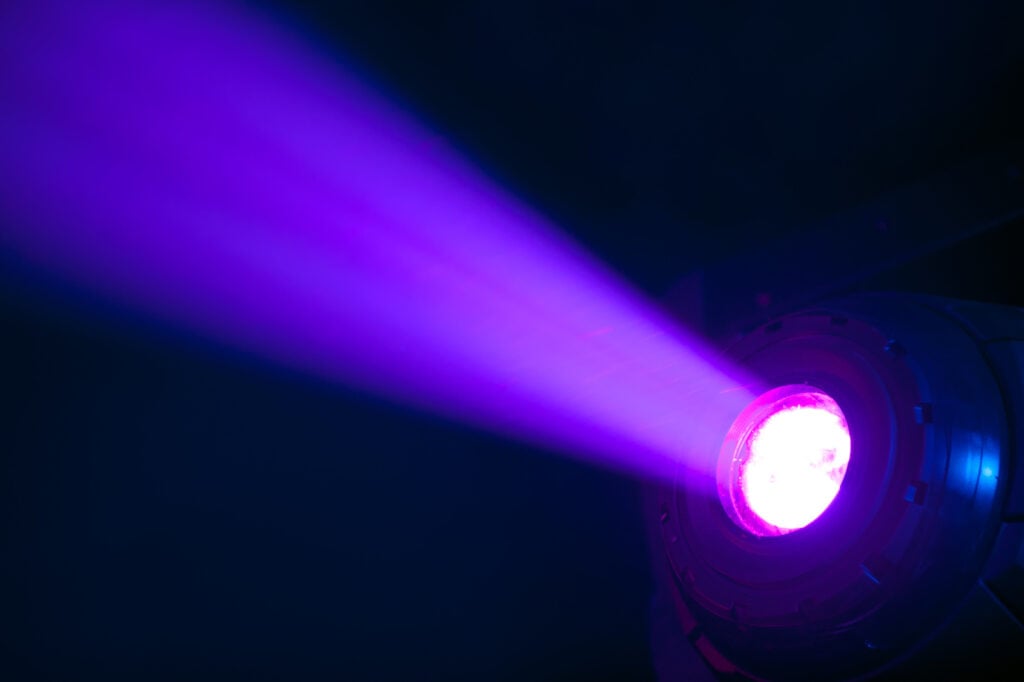 Purple light shining on black background
