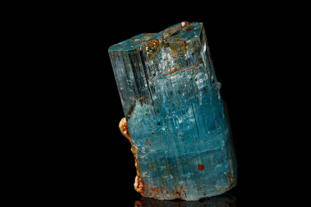 Close up of macro mineral stone aquamarine on a black background.