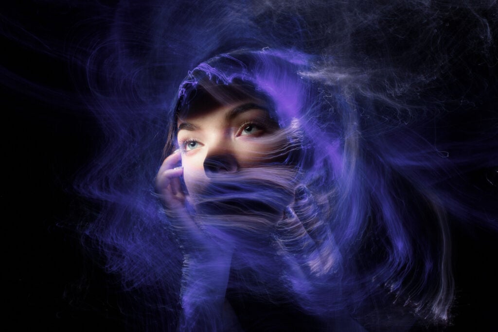 Close up of a woman's face with swirls of light illustrating the indigo aura.