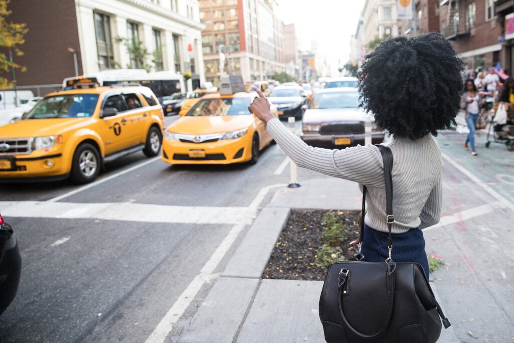 Woman hailing a taxi cab