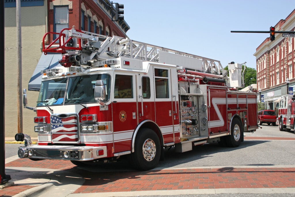 Red and white fire truck in the street