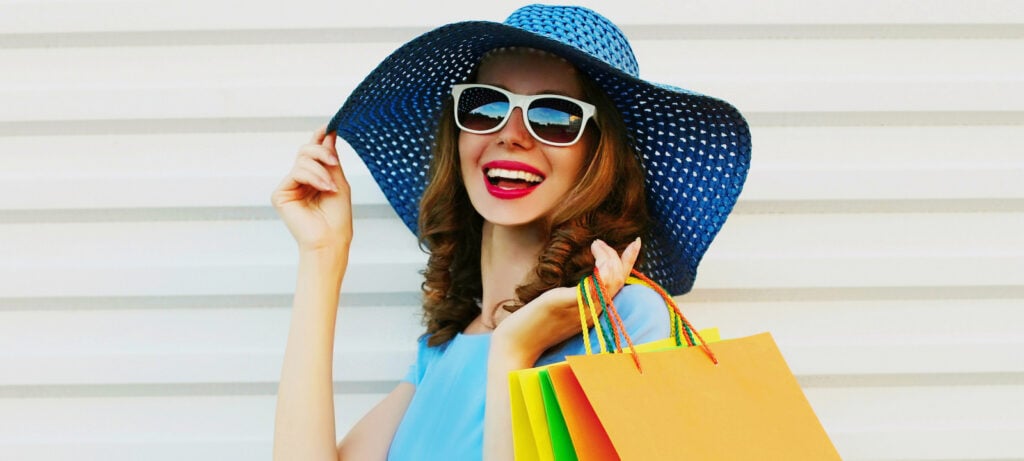 Woman in light blue shirt with royal blue sun hat.