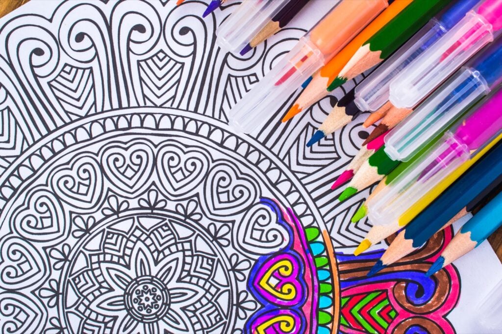 Closeup of mandala and color pencils