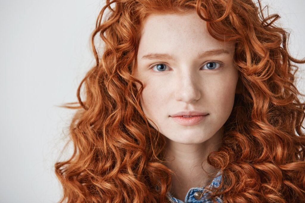 Closeup of redhead with long curly hair