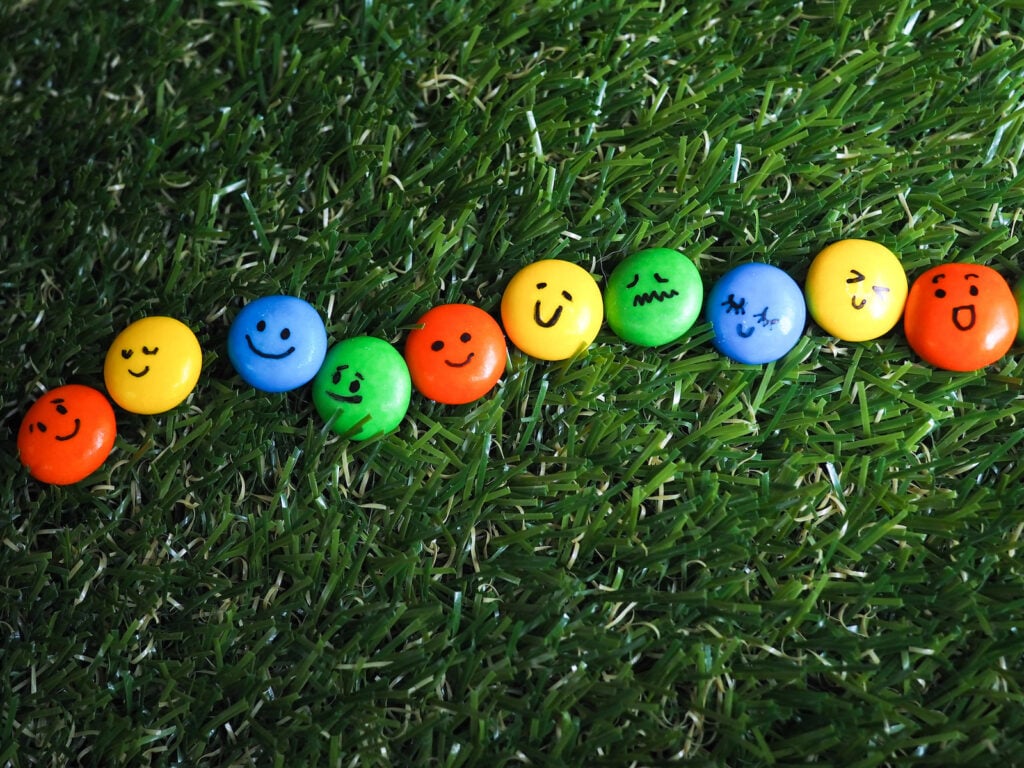 Colored candy faces in the grass