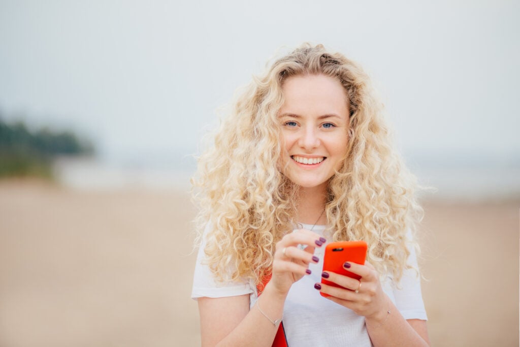 Woman with an orange cell phone