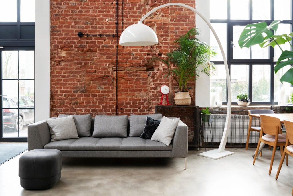 Living room interior in loft apartment with brick wall.