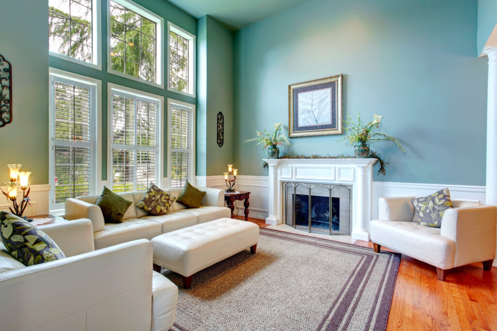 High ceiling robin's egg living room with white leather couch.