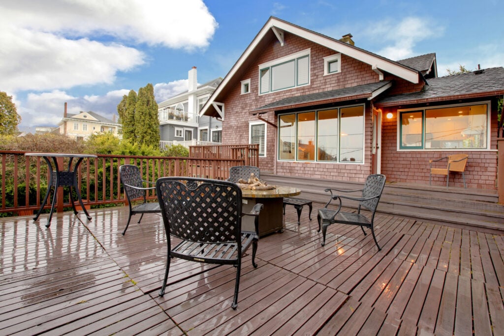 Large brown house with wooden deck