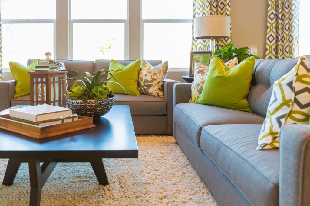 Lime green pillows on couch in beautiful living area.