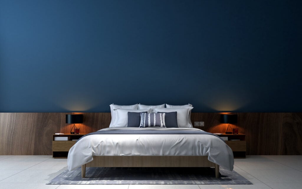 The modern bedroom interior design with navy blue wall.