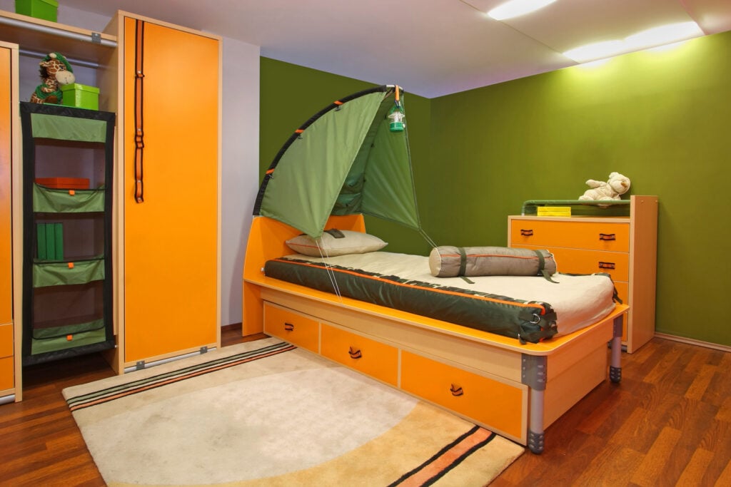 Child's bedroom with camping theme and olive green walls.