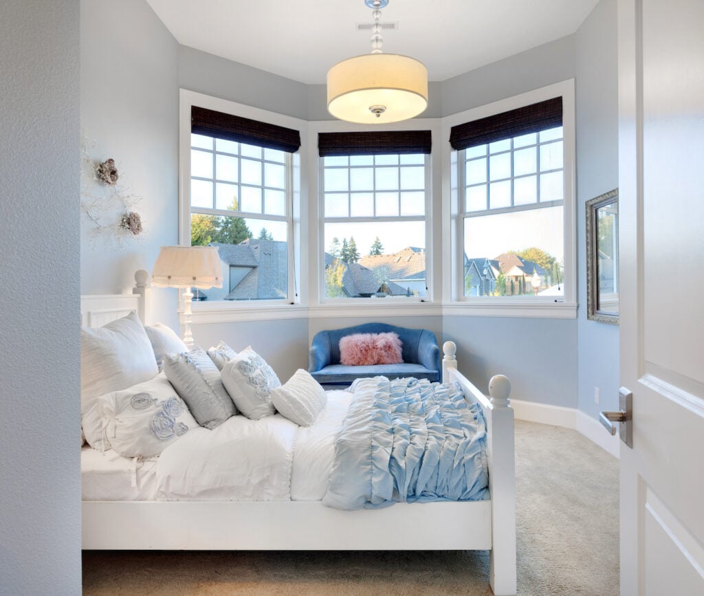 Girl's room with pale blue-gray walls.