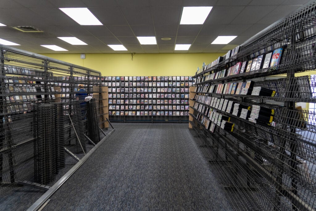 Interior of video store with charcoal gray carpet and celery green colored wall