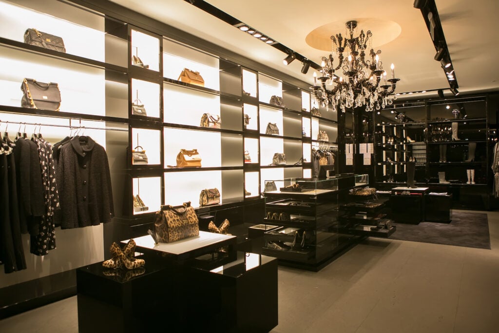 Interior of chic store with designer handbags and black display cases