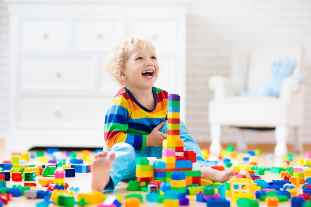 Child playing with colorful toys at home