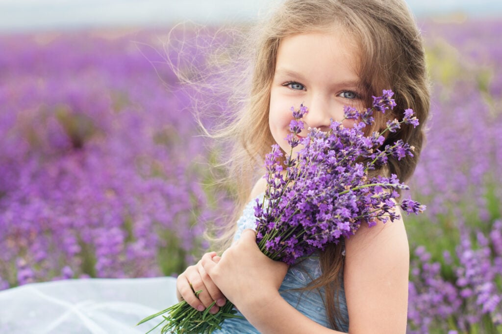 Girl holding purple flowers