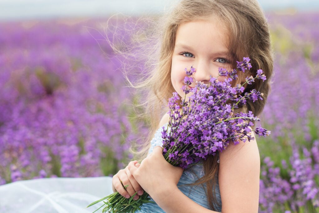 Girl holding purple flowers