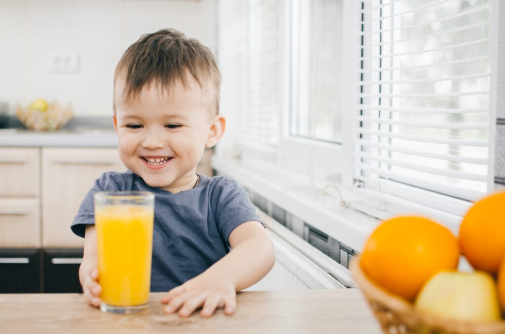 Happy kid with orange juice