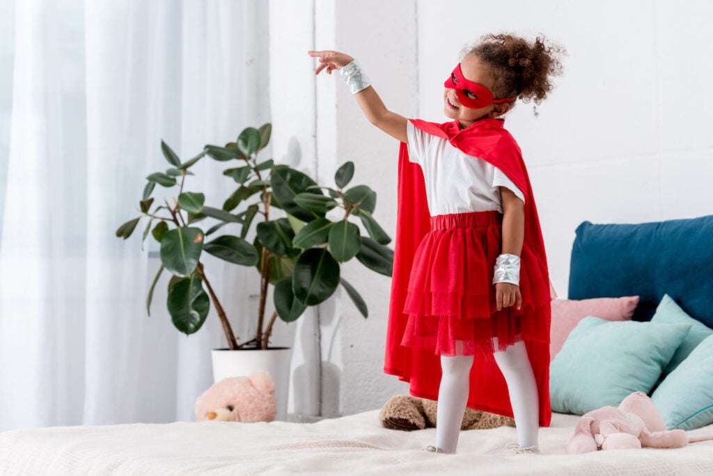 Kid wearing red superhero costume