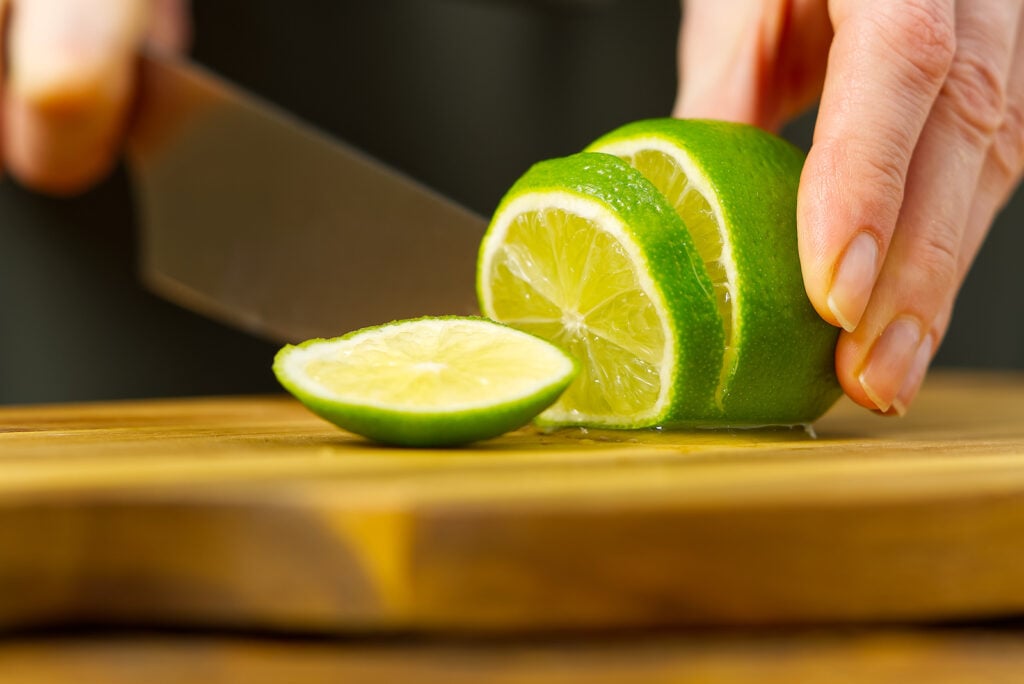 Person cutting lime fruit