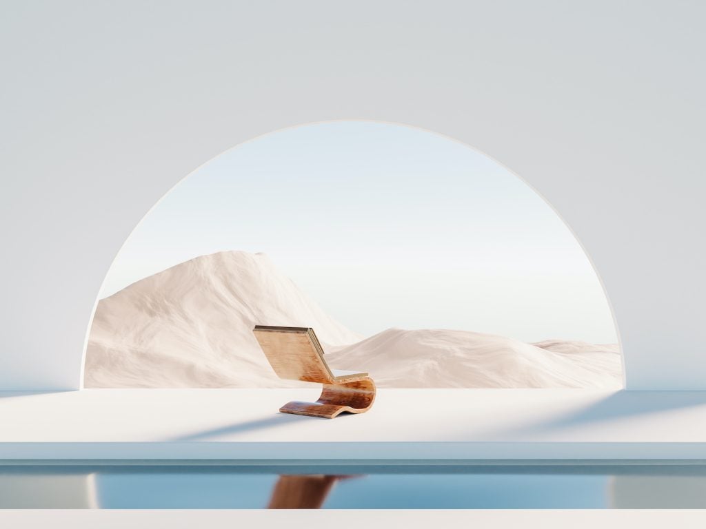 An empty chair by a pool looks out over white, dreamlike landscape