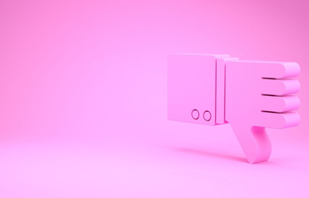 A 3D image of a pink "dislike" icon against a matching pink background