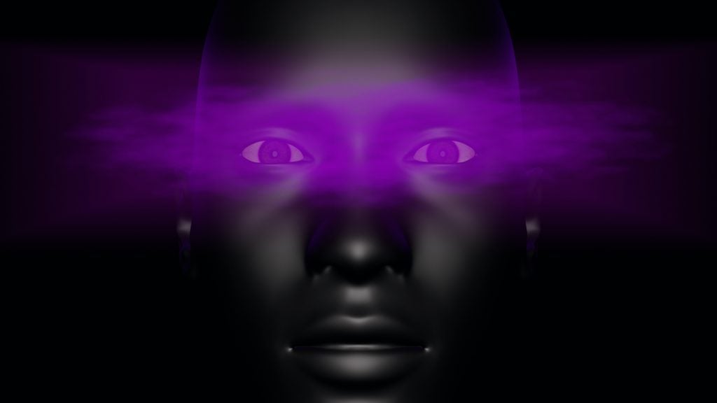 A purple mist floats across a man's eyes on a black background
