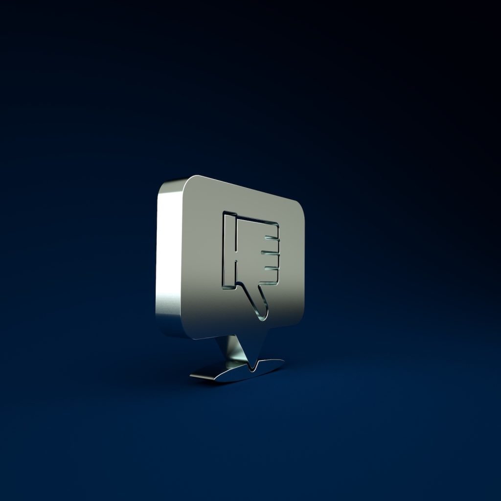 A 3D speech bubble with a thumbs-down emoji hovers against a dark blue background