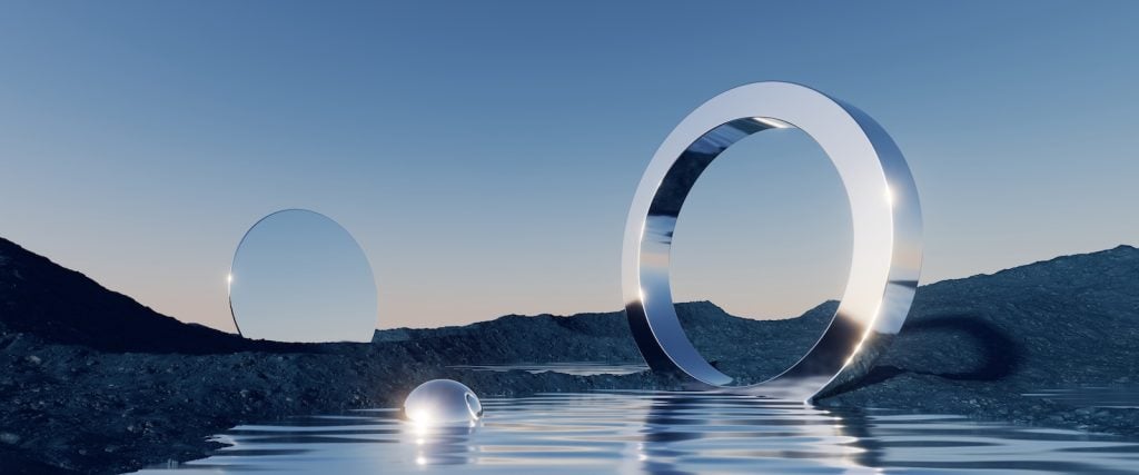 A surreal image shows a still lake with a large chrome ring and a silver ball. A circular mirror is in the background