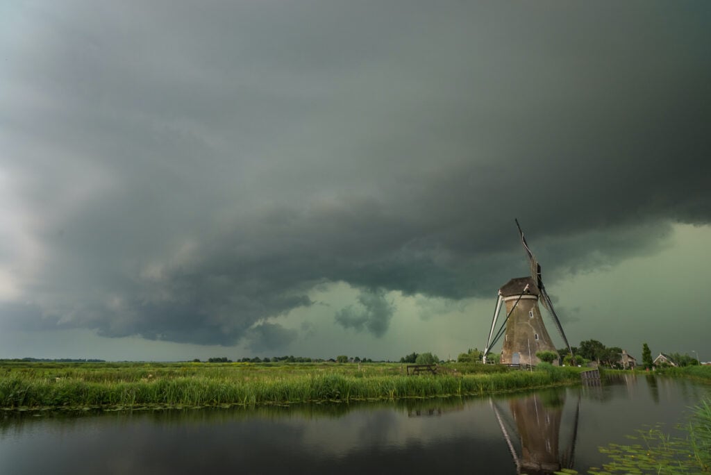 Green sky and storm cloud over a windmill in the Netherlands