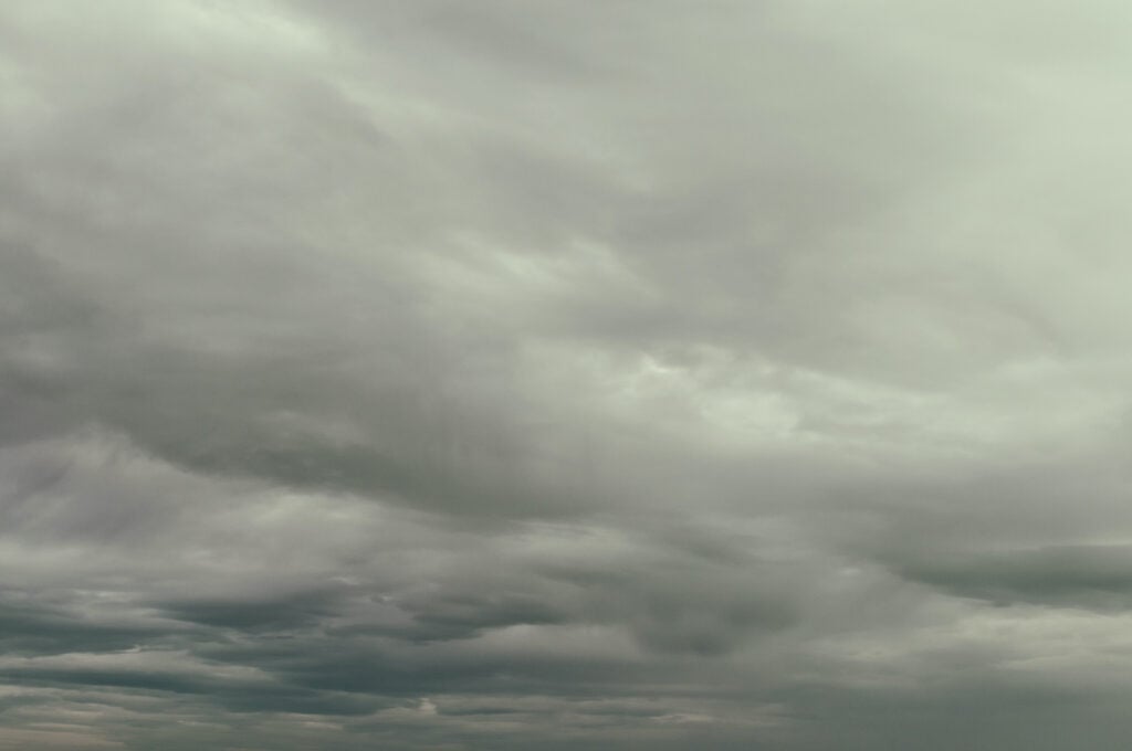 Grayish white stratus clouds blanket the sky