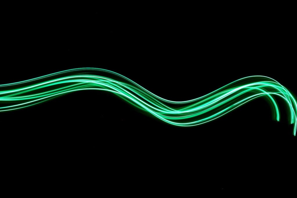An image of a green neon wave on a black background