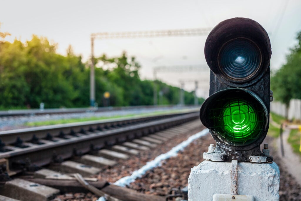 Close-up photo of a green railway signal light
