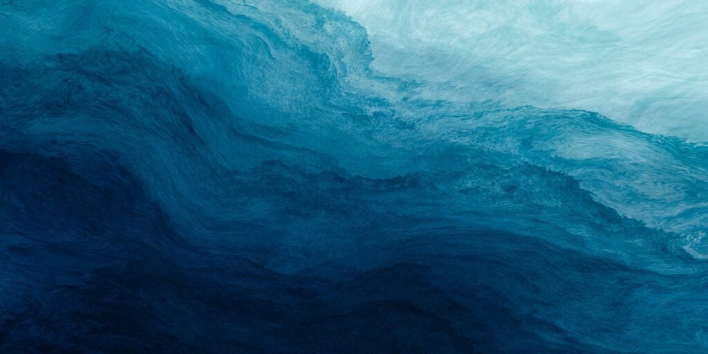 A soothing, watercolor-style wavy gradient of blue shades from light to dark