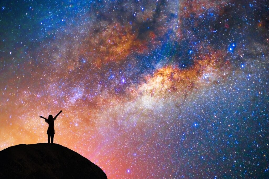 Person silhouette admiring the universe