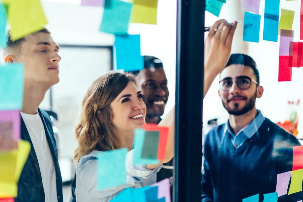 Employees looking at sticky notes