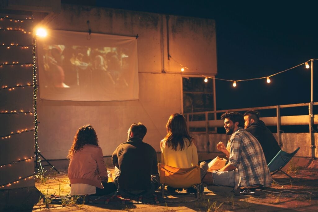 People watching movie on rooftop