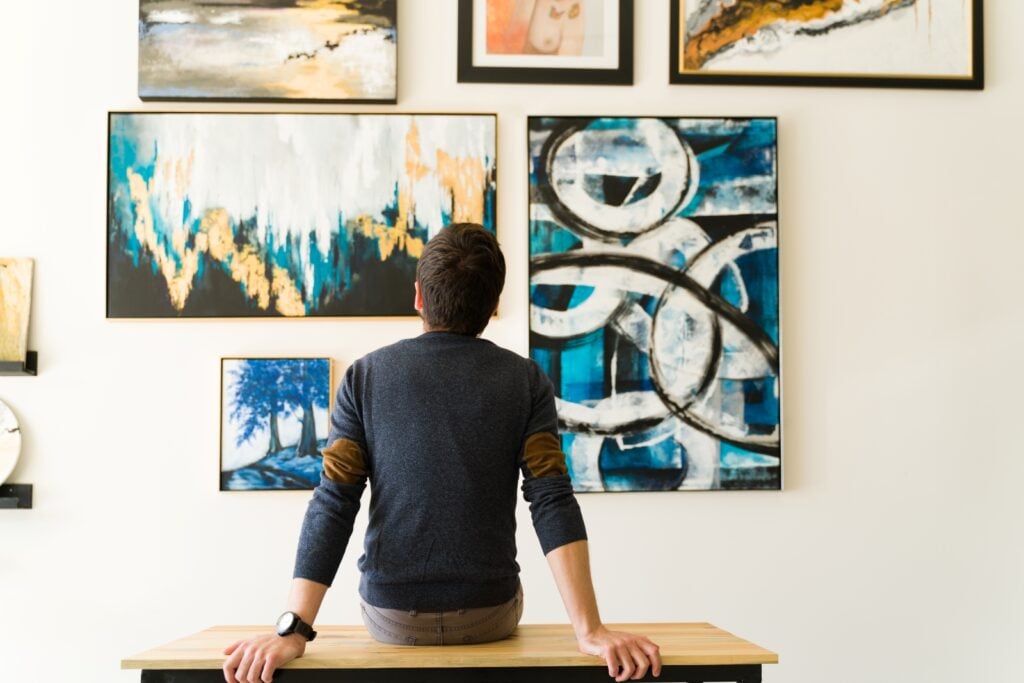 Person sitting and looking at art