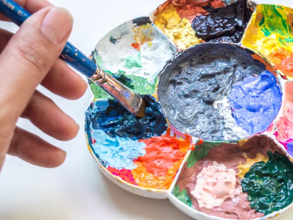 Mixing colorful paints with gray