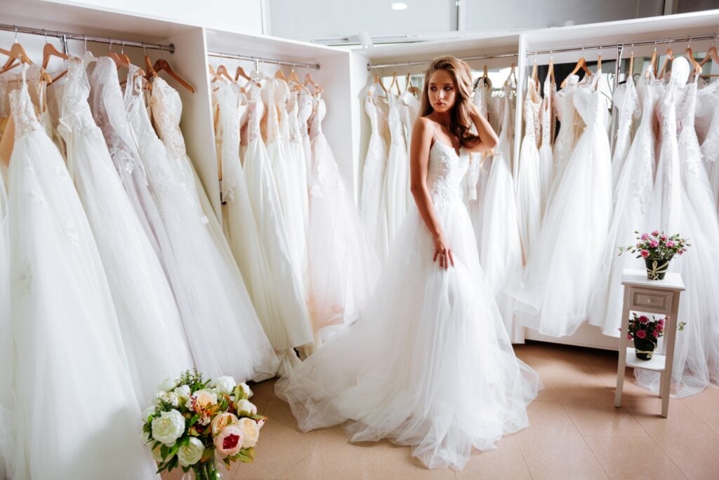 Woman trying on wedding dresses