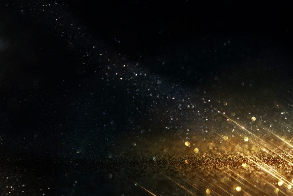 Gold glitter on black background