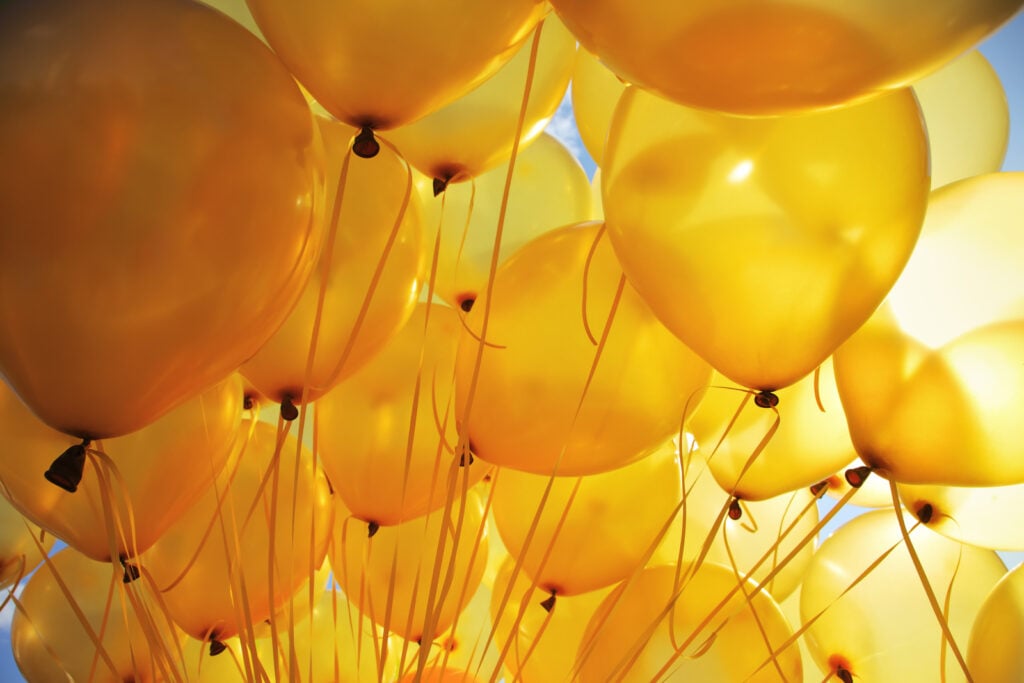 Group of yellow balloons on a sunny day