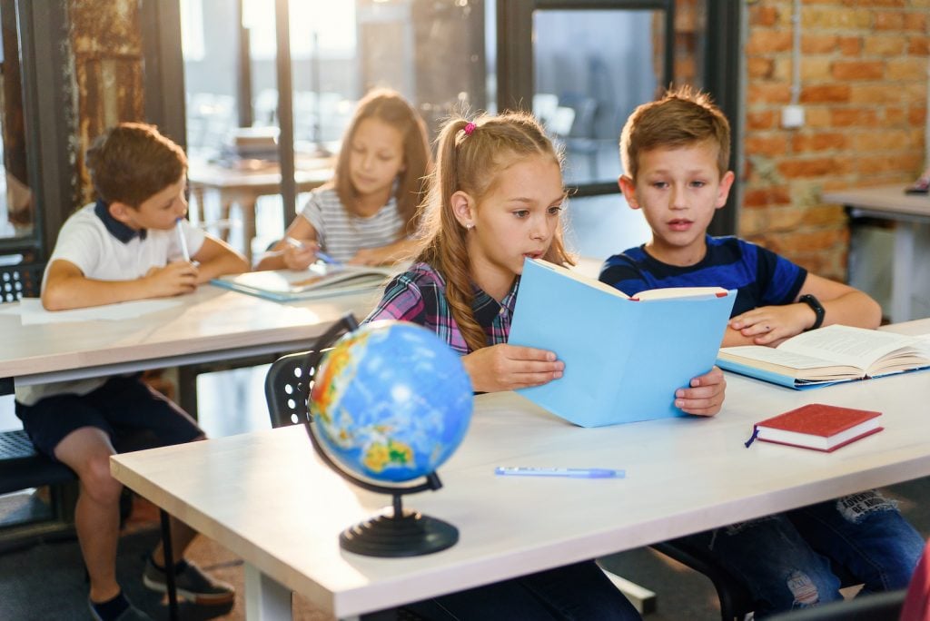 Kids reading books in history class