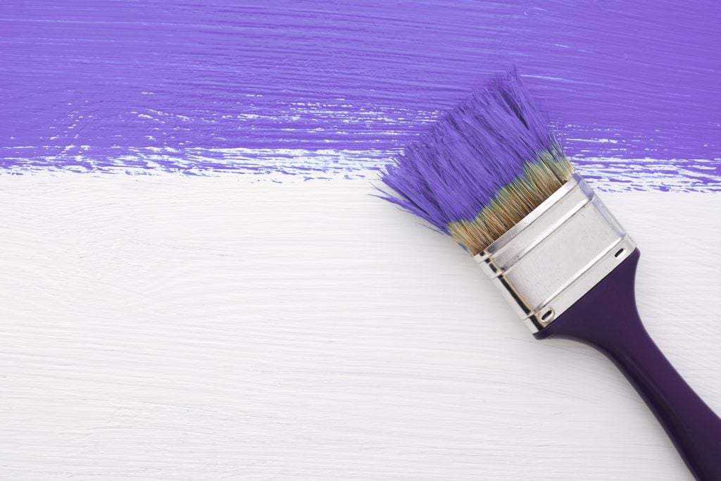 Painting with purple using a brush