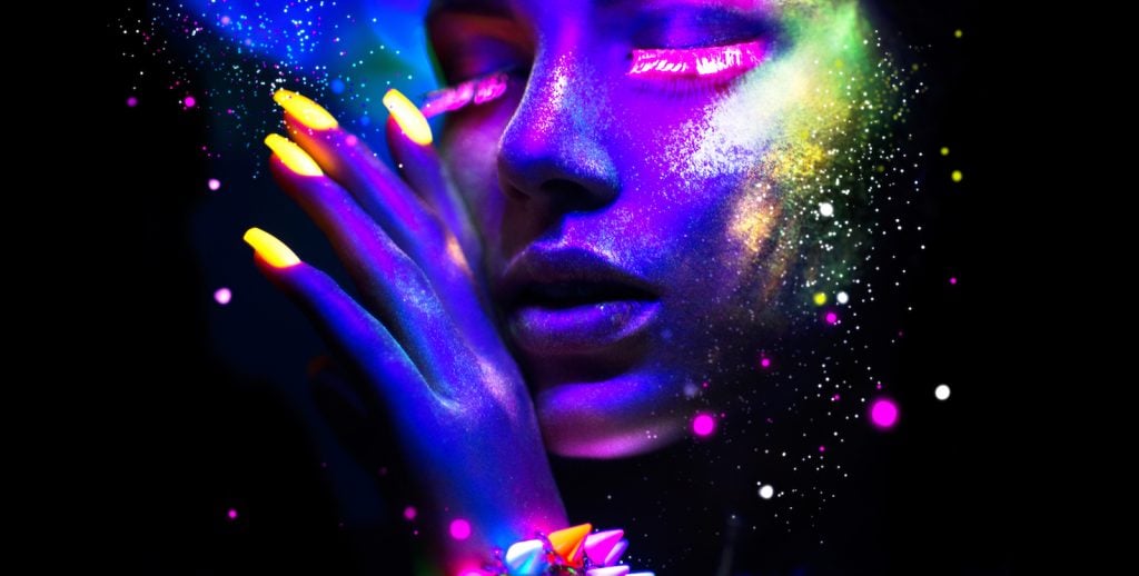 Woman glowing with different neon colors