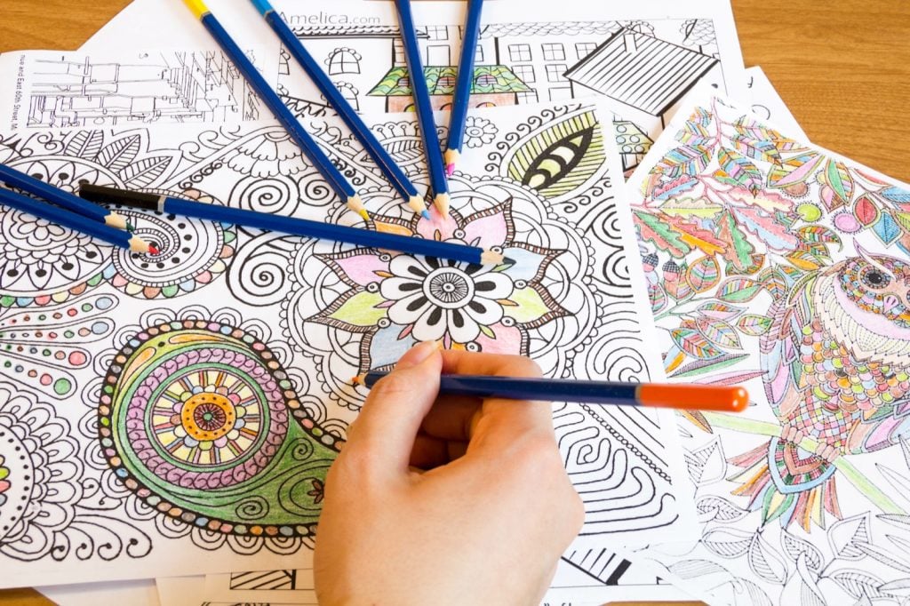 Adult relieving stress with pencils and coloring books