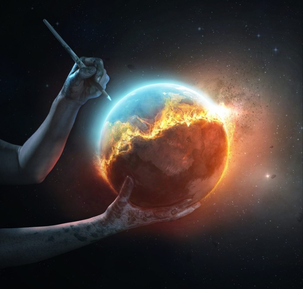 A surreal image of a colorful world on fire being saved by an artists hands