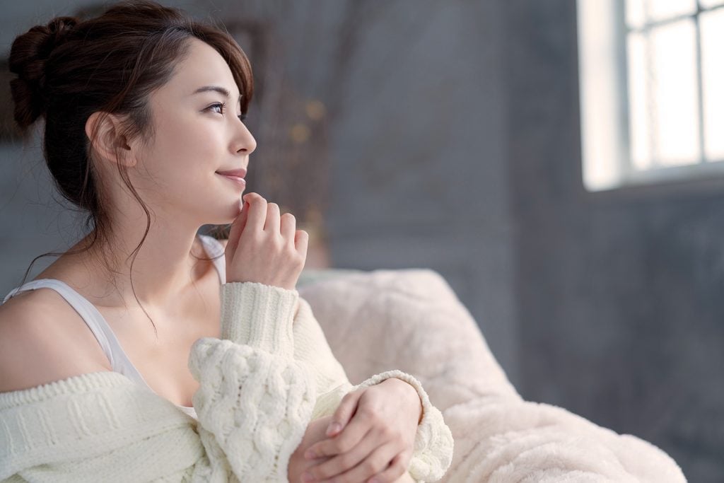 Asian woman in soft white sweater